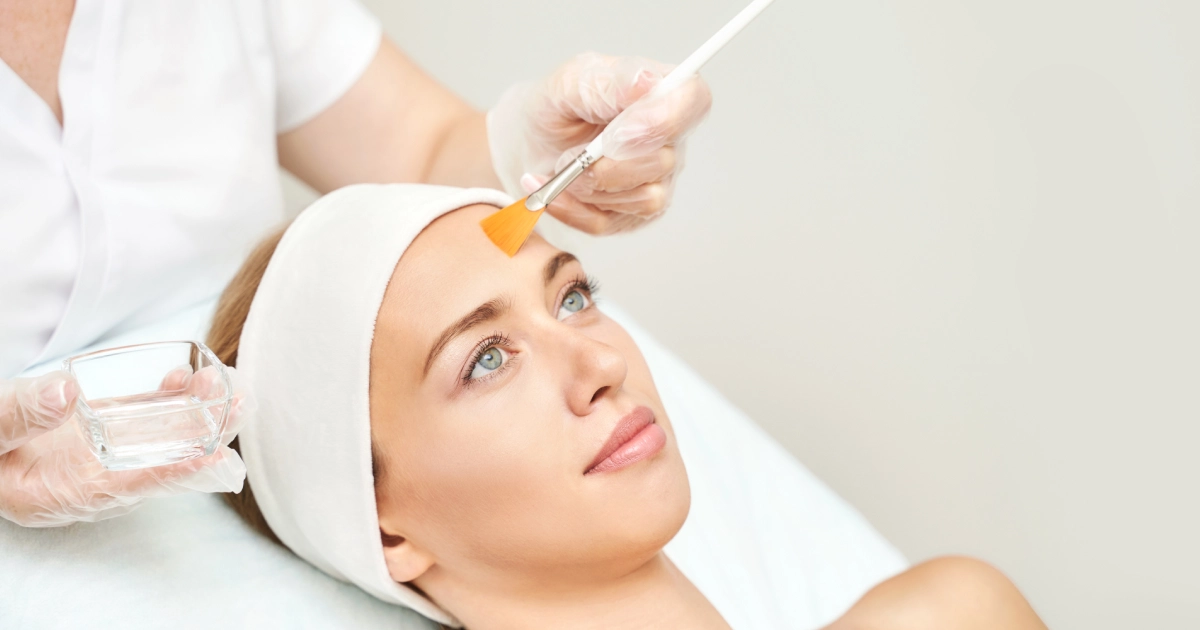 Woman receiving chemical peel facial treatment at spa in Tulsa, OK